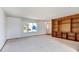 Living room features a wood-panel built-in bookshelf and neutral carpeting at 1487 S Zeno Way, Aurora, CO 80017