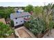 Aerial rear view features a backyard with mature trees and a patio at 1487 S Zeno Way, Aurora, CO 80017
