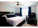Spacious bedroom features a large bed, ceiling fan, and window, creating a relaxing retreat at 3825 S Monaco Pkwy # 111, Denver, CO 80237