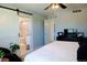 Primary bedroom with ensuite bath featuring a sliding barn door at 3825 S Monaco Pkwy # 111, Denver, CO 80237