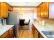Galley kitchen with stainless steel appliances and tile backsplash at 3825 S Monaco Pkwy # 111, Denver, CO 80237