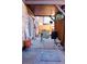 Covered patio includes a gas grill, outdoor seating, and a mosaic-tiled fire pit at 3825 S Monaco Pkwy # 111, Denver, CO 80237
