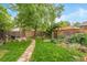 Spacious backyard offering a stone walkway, a patio with furniture, and a wooden fence for privacy at 4508 W 34Th Ave, Denver, CO 80212