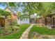 Charming blue house with a lush backyard, stone walkway, and well-manicured landscaping at 4508 W 34Th Ave, Denver, CO 80212