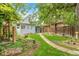 Charming light-blue home featuring a well-kept backyard with a stone pathway and lush landscaping at 4508 W 34Th Ave, Denver, CO 80212