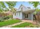 Light-blue home with a cozy backyard, featuring a stone patio, quaint landscaping and a wooden fence at 4508 W 34Th Ave, Denver, CO 80212