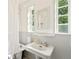 Bright bathroom features a pedestal sink, vintage fixtures, and natural light from large windows at 4508 W 34Th Ave, Denver, CO 80212