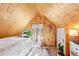 Cozy attic bedroom with wood-paneled ceiling and fireplace at 4508 W 34Th Ave, Denver, CO 80212