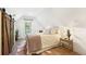 Cozy bedroom with wood floors, ample natural light, and a barn door adding rustic charm at 4508 W 34Th Ave, Denver, CO 80212