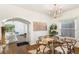 Elegant dining room featuring hardwood floors, modern chandelier, glass table, stylish chairs, and ample natural light at 4508 W 34Th Ave, Denver, CO 80212