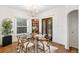 Bright dining room featuring a modern chandelier, glass-top table, and decorative accents at 4508 W 34Th Ave, Denver, CO 80212