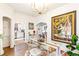 Elegant dining room with hardwood floors, glass-top table, and a view of the kitchen at 4508 W 34Th Ave, Denver, CO 80212