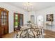 Dining room features a glass-top table, hardwood floors, and vintage china cabinet at 4508 W 34Th Ave, Denver, CO 80212