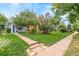 Attractive home featuring a landscaped front yard with mature trees, a blue exterior, and inviting front porch at 4508 W 34Th Ave, Denver, CO 80212