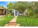 Charming light-blue home with a well-manicured front yard, stone walkway, and mature shade tree at 4508 W 34Th Ave, Denver, CO 80212