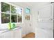 Bright laundry area featuring a stackable washer and dryer, a large window and ample sunlight at 4508 W 34Th Ave, Denver, CO 80212