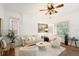 Bright and airy living room with hardwood floors, ceiling fan, ample light, and comfortable seating arrangement at 4508 W 34Th Ave, Denver, CO 80212