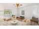 Inviting living room with hardwood floors, white walls, large windows, ceiling fan and cozy seating at 4508 W 34Th Ave, Denver, CO 80212