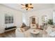 Open living room flowing into dining area, showcasing hardwood floors, stylish seating, and arched doorways at 4508 W 34Th Ave, Denver, CO 80212