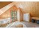 Attic living space featuring natural wood finishes, unique ceiling details, and ample sunlight at 4508 W 34Th Ave, Denver, CO 80212