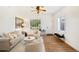 Bright and airy living room featuring hardwood floors, white walls, neutral decor, ceiling fan and ample light at 4508 W 34Th Ave, Denver, CO 80212