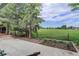 Expansive green backyard with mature trees, a garden bed, and a view of open fields at 14650 Tejon St, Broomfield, CO 80023