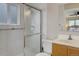 Bathroom with tiled walls, a glass shower door and a wood vanity with a mirror above the sink at 14650 Tejon St, Broomfield, CO 80023