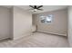 A bright bedroom with carpet, large windows, and a built-in desk with storage space at 14650 Tejon St, Broomfield, CO 80023