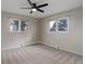 Spacious bedroom with two windows, neutral carpeting and baseboard heating for added comfort at 14650 Tejon St, Broomfield, CO 80023