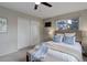 Comfortable bedroom featuring a ceiling fan, large closet and a cushioned bench in front of the bed at 14650 Tejon St, Broomfield, CO 80023