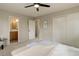 Cozy bedroom with closet, ceiling fan, and open door to a bathroom with an oak vanity and tile floor at 14650 Tejon St, Broomfield, CO 80023