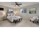 Well-lit bedroom featuring carpet floors, a queen bed, an accent chair, and two bedside lamps at 14650 Tejon St, Broomfield, CO 80023