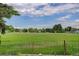 Expansive green field surrounded by a fence, showcasing the potential for various outdoor activities at 14650 Tejon St, Broomfield, CO 80023