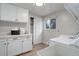 Laundry room features white cabinets, a utility sink, a window, and appliances at 14650 Tejon St, Broomfield, CO 80023