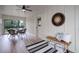 Relaxing sunroom with wood-look floors, bright white walls, and a decorative wall mirror at 14650 Tejon St, Broomfield, CO 80023