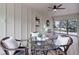 Cozy sunroom featuring wood-look floors and a glass table with wicker chairs for relaxed living at 14650 Tejon St, Broomfield, CO 80023