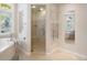 Bright bathroom with walk-in shower, towel rack and separate soaking tub at 4800 E Cedar Ave, Denver, CO 80246