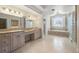 Bathroom with double vanity, glass block shower, soaking tub, and a separate water closet at 4800 E Cedar Ave, Denver, CO 80246