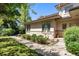 The side of the house with brick accents, landscaping, and a well-manicured lawn at 4800 E Cedar Ave, Denver, CO 80246