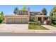 Charming home with a three-car garage, well-kept lawn, and inviting front entrance at 4800 E Cedar Ave, Denver, CO 80246