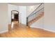 Grand foyer showcasing a staircase with iron railings and hardwood floors, and arched doorway at 4800 E Cedar Ave, Denver, CO 80246