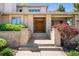 Close-up of the grand double-door entrance with brick pillars and well-maintained landscaping at 4800 E Cedar Ave, Denver, CO 80246