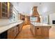 Spacious kitchen with custom cabinetry, large center island, and stainless steel appliances at 4800 E Cedar Ave, Denver, CO 80246