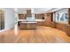 Open-concept kitchen featuring a large island, custom cabinets, and modern appliances at 4800 E Cedar Ave, Denver, CO 80246