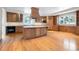 Gourmet kitchen featuring custom cabinets, a center island, and stainless steel appliances at 4800 E Cedar Ave, Denver, CO 80246