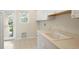 Bright laundry room with a utility sink, white cabinets, and access to the outdoors at 4800 E Cedar Ave, Denver, CO 80246