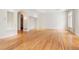 Open living area with hardwood floors and an arched doorway at 4800 E Cedar Ave, Denver, CO 80246