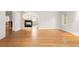 Open concept living room with hardwood floors, fire place, lots of light, and neutral paint at 4800 E Cedar Ave, Denver, CO 80246
