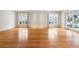 Open-concept living area with hardwood floors and natural light from the windows at 4800 E Cedar Ave, Denver, CO 80246