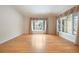 Bright and airy living room featuring hardwood floors and large windows with decorative curtains at 4800 E Cedar Ave, Denver, CO 80246